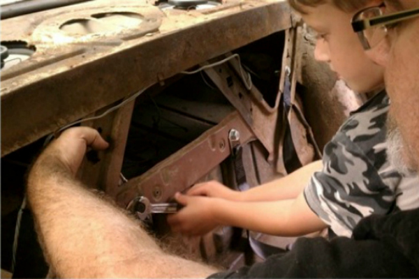 Gabe and William fixing Cars