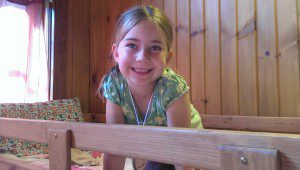 Happy to be on the top bunk for her first summer camp experience!